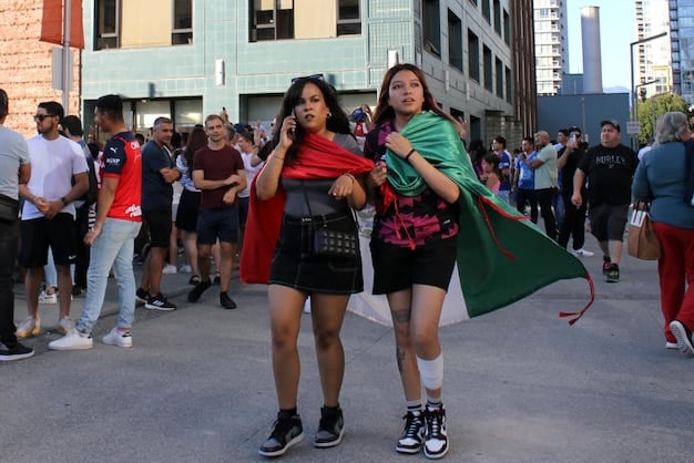 A diverse group of Peruvian-Americans gathered at a cultural event in a US city, showcasing their close-knit community ties and strong connections to their homeland. The scene captures a sense of pride and unity.