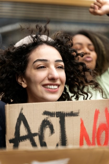 A photograph of a peaceful protest in Peru, with signs in Spanish advocating for human rights and environmental protection. The image represents the social and political activism taking place in Peru.
