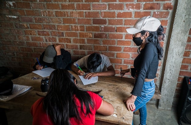 A Peruvian-American community organization hosting a voter registration drive, with volunteers assisting people in filling out registration forms. The scene shows engagement and active participation.
